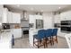 A well-lit kitchen with stainless steel appliances, a stylish range hood, and a breakfast bar at 3622 S Setting Sun Ln, New Palestine, IN 46163