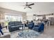 Open-concept living space with a stylish rug, blue seating, and plenty of natural light at 3622 S Setting Sun Ln, New Palestine, IN 46163