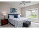 Cozy main bedroom with a large window, ceiling fan, and comfortable queen-size bed at 3622 S Setting Sun Ln, New Palestine, IN 46163