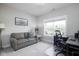 Functional home office featuring a comfortable sofa, a desk area, and natural light from the window at 3622 S Setting Sun Ln, New Palestine, IN 46163