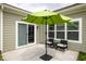 Cozy patio with a green umbrella, perfect for outdoor seating and relaxation at 3622 S Setting Sun Ln, New Palestine, IN 46163
