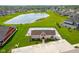 Aerial view of community pool and clubhouse, surrounded by lush landscaping and parking at 3622 S Setting Sun Ln, New Palestine, IN 46163