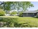 Large green backyard featuring grass and the back exterior of the house at 370 N Bazil Ave, Indianapolis, IN 46219