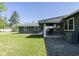 A cozy porch with rocking chairs overlooks the spacious backyard and well-maintained lawn at 370 N Bazil Ave, Indianapolis, IN 46219