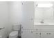 Bathroom with toilet, sink and storage cabinet with a simple, clean design at 370 N Bazil Ave, Indianapolis, IN 46219