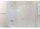 Clean bright bathroom features a tub with chrome shower head and tiled surround at 370 N Bazil Ave, Indianapolis, IN 46219