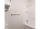Bright bathroom features a tub with chrome shower head and tiled surround at 370 N Bazil Ave, Indianapolis, IN 46219
