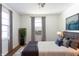 Well-lit bedroom with a comfortable bed, hardwood floors, and soft natural light at 370 N Bazil Ave, Indianapolis, IN 46219