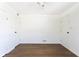 Spacious bedroom with hardwood floors and multiple doors for easy access at 370 N Bazil Ave, Indianapolis, IN 46219