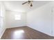 A clean and bright empty bedroom with hardwood floors and ceiling fan at 370 N Bazil Ave, Indianapolis, IN 46219