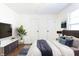 Nicely staged bedroom with TV, hardwood floors, natural light, and calming decor at 370 N Bazil Ave, Indianapolis, IN 46219