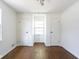 Hardwood flooring in a vacant bedroom with double closets and a window at 370 N Bazil Ave, Indianapolis, IN 46219