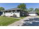 View of home's exterior, featuring a detached garage, and long driveway at 370 N Bazil Ave, Indianapolis, IN 46219
