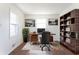 Bright home office featuring a stylish desk, chair, bookshelf, and natural light at 370 N Bazil Ave, Indianapolis, IN 46219