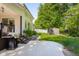 Backyard featuring a lush lawn, mature trees, storage shed, and concrete patio at 3781 S Station Dr, Columbus, IN 47203