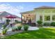Spacious backyard featuring a patio with seating, lush lawn, and mature trees at 3781 S Station Dr, Columbus, IN 47203