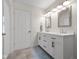 Bright bathroom featuring a double vanity with framed mirrors and a glass enclosed shower at 3781 S Station Dr, Columbus, IN 47203