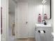 Well-lit bathroom with white vertical shiplap and modern fixtures and wood-look flooring at 3781 S Station Dr, Columbus, IN 47203
