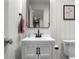 Stylish half-bathroom with white vanity, black accents, and modern mirror at 3781 S Station Dr, Columbus, IN 47203