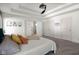 This bedroom features a tray ceiling, white trim, and a view to the ensuite bath at 3781 S Station Dr, Columbus, IN 47203