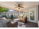 Relaxing covered deck with wicker furniture, ceiling fan, and view of backyard at 3781 S Station Dr, Columbus, IN 47203