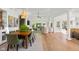 Open-concept dining and living area featuring hardwood floors, ample natural light, and stylish furnishings at 3781 S Station Dr, Columbus, IN 47203
