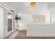 Bright entryway featuring hardwood floors, a stylish light fixture, and a decorative macrame wall hanging at 3781 S Station Dr, Columbus, IN 47203