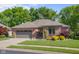 Charming single-story brick home featuring a two-car garage and meticulously landscaped front yard at 3781 S Station Dr, Columbus, IN 47203