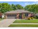 Charming single-story brick home featuring a two-car garage and meticulously landscaped front yard at 3781 S Station Dr, Columbus, IN 47203