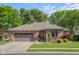 Charming brick home with a well-manicured lawn, mature landscaping, and attached garage at 3781 S Station Dr, Columbus, IN 47203