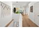 Bright hallway with hardwood floors leading to a living area with large windows and high ceilings at 3781 S Station Dr, Columbus, IN 47203