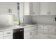 Clean kitchen with stainless steel sink, tile backsplash, and white cabinets at 3781 S Station Dr, Columbus, IN 47203