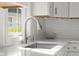 New modern faucet on a stainless sink with bright window in this updated kitchen at 3781 S Station Dr, Columbus, IN 47203