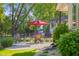 Outdoor patio area with seating, umbrella, and well-manicured landscaping at 3781 S Station Dr, Columbus, IN 47203