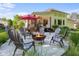 Backyard patio area featuring fire pit, patio furniture and well-manicured lawn at 3781 S Station Dr, Columbus, IN 47203