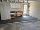 Basement space featuring gray carpet, a workbench, and cabinets at 3917 Knoll Wood Ln, Anderson, IN 46011