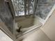 Bathroom featuring a spa tub under a window, tile flooring, and blue floral wallpaper at 3917 Knoll Wood Ln, Anderson, IN 46011