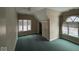 Bedroom featuring neutral walls, green carpeting, and multiple windows for natural light at 3917 Knoll Wood Ln, Anderson, IN 46011
