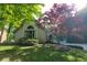 Exterior of a light brick home with mature trees and an arched window detail at 3917 Knoll Wood Ln, Anderson, IN 46011