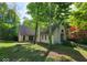 Exterior of a light brick home with mature trees and an arched window detail at 3917 Knoll Wood Ln, Anderson, IN 46011