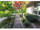 A beautiful walkway leads to a well-maintained light brick home surrounded by lush landscaping at 3917 Knoll Wood Ln, Anderson, IN 46011