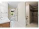 Bathroom with a tiled shower and an adjacent vanity with wood cabinets at 4139 Bayberry Ct, Greenwood, IN 46143