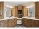 Bathroom featuring double sinks, wooden cabinets, and full mirrors at 4139 Bayberry Ct, Greenwood, IN 46143