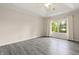 A well-lit bedroom with hardwood floors, a tray ceiling, and a view of the yard at 4139 Bayberry Ct, Greenwood, IN 46143