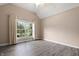 Spacious bedroom with a large window offering backyard views and modern flooring at 4139 Bayberry Ct, Greenwood, IN 46143