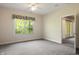 Bedroom with a carpet, a big window with backyard views, and an adjacent doorway at 4139 Bayberry Ct, Greenwood, IN 46143