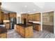 Spacious kitchen with wood cabinets, a center island with granite countertop, and stainless steel appliances at 4139 Bayberry Ct, Greenwood, IN 46143