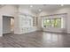 Open-concept living space featuring hardwood floors, large window, and custom built-in shelving at 4139 Bayberry Ct, Greenwood, IN 46143