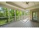 Screened-in porch offering natural light, ceiling fan, wood floor, and outdoor access with scenic backyard views at 4139 Bayberry Ct, Greenwood, IN 46143