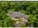 Aerial view of a beautifully landscaped property featuring a pool and an outdoor fire pit at 4242 Watson Rd, Greenwood, IN 46143